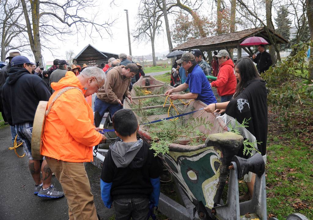 Tribal members prepare a canoe before it&rsquo;s removed from Pioneer Memorial Park in Sequim on April 8. Sequim Gazette photo by Michael Dashiell