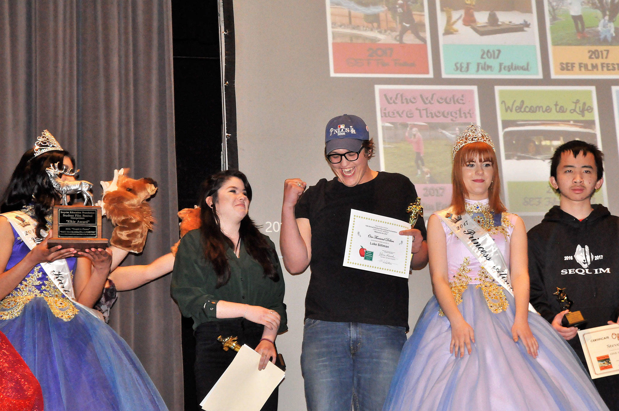 Emma Gallaher and Luke Silliman celebrate winning the audience choice award, or the Elkie, at the Student Film Festival on April 21, in Sequim High School. The friends&rsquo; film &ldquo;Welcome to Life&rdquo; also won first place and a $1,000 scholarship from the Sequim Education Foundation. Sequim Gazette photo by Matthew Nash
