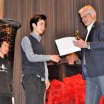 Raymond, right, and Steven Lam accept second place at the Student Film Festival from Sequim Superintendent Gary Neal for their film &ldquo;One Spring Day.&rdquo;