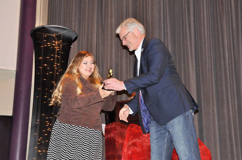 Victoria Hall accepts third place and a $500 scholarship from Sequim Schools&rsquo; Superintendent Gary Neal on April 21 for her film &ldquo;The Definition of Happiness&rdquo; at the Student Film Festival. Sequim Gazette photo by Matthew Nash