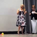 Emcees Annie Armstrong and Abygail Mundy share a joke to introduce one of nine films at the Student Art Show on April 21. Sequim Gazette photo by Matthew Nash