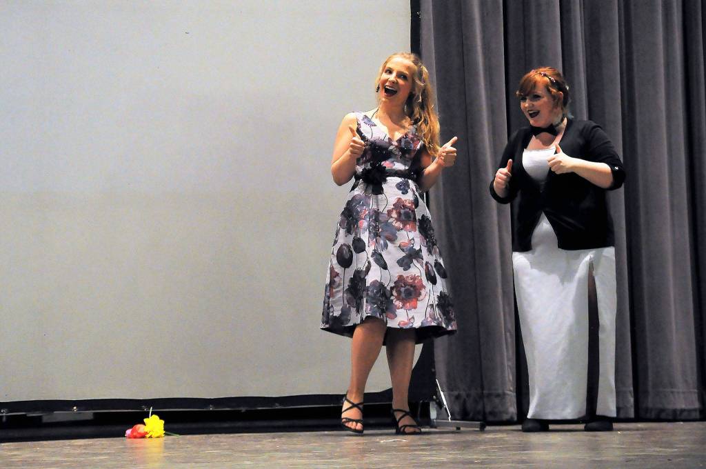 Emcees Annie Armstrong and Abygail Mundy share a joke to introduce one of nine films at the Student Art Show on April 21. Sequim Gazette photo by Matthew Nash
