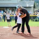 Above, Naomi Perry gives son Kingston a big hug after throwing out one of two opening day ceremonial first pitches. Sequim Little League paid tribute to Perry&rsquo;s father Dan, a longtime local youth sports advocate, on April 15.                                 At left, brothers Trevor Goff, 8, (background) and Connor Goff, 9, have a game of catch after opening Sequim Little League Opening Day ceremonies.