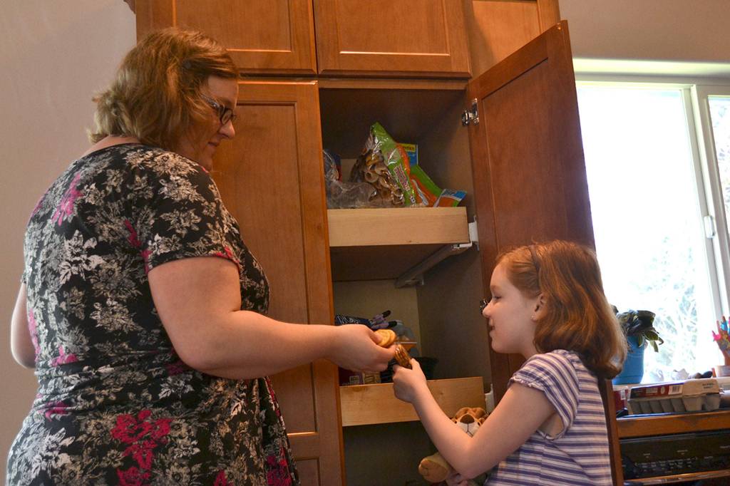 Eating healthy food is an important part of controlling blood sugars for diabetics. For Chloe Loucks, right, she checks with her mom Angela most of the time before eating snacks like peanut butter crackers, applesauce and yogurt which can bring blood sugar levels up.