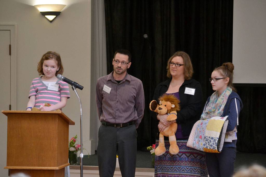 Chloe Loucks, left, stands with her family, dad Larry, mom Angela, and sister Emily, on March 8 at the Regional Outreach Luncheon Meeting for Clallam & Jefferson County at Sunland Golf & Country Club. Chloe and Larry spoke about how much Seattle Children&rsquo;s Hospital has helped her with treatment. The guilds have helped more than 1,400 patients receive 
$1.2 million in uncompensated care. Sequim Gazette photo by Matthew Nash