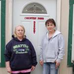 Country Paws Resort owner Shelley Denton, left, stands with employee Noelle Geyer, right, in front of their office building after discussing how the company was scammed from a private advertising company claiming to be through the Sequim-Dungeness Valley Chamber of Commerce. Sequim Gazette photo by Erin Hawkins
