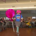 Jason Bausher, an employee of First Federal Bank, holds a large lollipop prop during a performance at the Crazy Daze Breakfast at the Sunland Golf Country Club on Friday, April 5. Sequim Gazette photo by Erin Hawkins