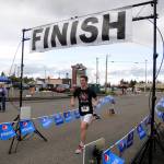 More than 70 participants break from the starting line at Saturday&rsquo;s Sequim Irrigation Festival Fun Run 5k. Crossing hte finish line in first place is Sequim teen Nate Despain. Sequim Gazette photo by Michael Dashiell