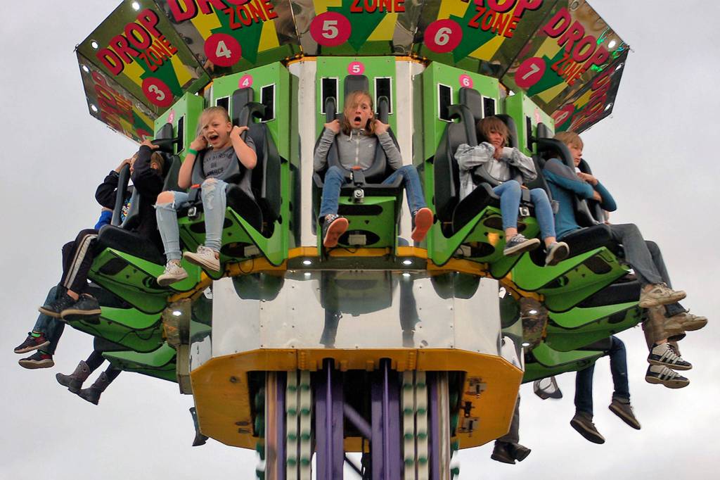 Friends, from left, Emma Swagerty, 12, Natalie Robinson, 10, and Trinity Jones, 11, from Sequim enjoy the last drop on the Drop Zone ride on Saturday night at the Sequim Irrigation Festival&rsquo;s carnival while celebrating Swagerty&rsquo;s birthday. Sequim Gazette photo by Matthew Nash