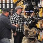 Norm and Travis Stoken of Sequim try on new gloves last week as they visit Coastal Farm & Ranch in Sequim. &ldquo;I think some of the other stores are going to see some competition,&rdquo; Travis said. Sequim Gazette photo by Matthew Nash