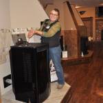 Kim Beus, floor supervisor, pours pellets into the pellet Allure 50 stove in Coastal&rsquo;s hearth section that features more than 50 pellet, propane and wood stoves. Grills also are for sale nearby with weekend demos occurring often, staff said.