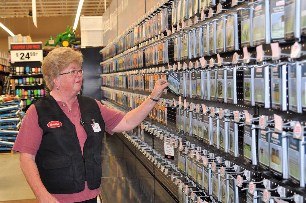 Jainie McDermott, animal health associate, pulls a card from the feed and fencing board for a customer. The cards can be taken to an associate and staff will bring you the animal feed or item purchased. Sequim Gazette photos by Matthew Nash