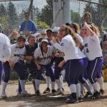 Adrianne Haggerty is greeted at home plate by a pack of happy Wolves after her home run against Olympic on Saturday during Sequim&rsquo;s 9-1 win. Photos by Lonnie Archibald