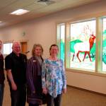 Aside from new lighting in the Guy Cole Convention Center, one of the highlights is a new elk glass art piece by Millie Harrell, on right. Here she stands with Sequim City Manager Charlie Bush, Mayor Dennis Smith and Sharon DelaBarre, chairman of the Sequim Arts Advisory Commission, who helped push the remodel and art installation forward in different capacities. Sequim Gazette photo by Matthew Nash