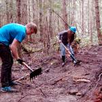 Sequim High School students Sequoia Swindler, left, and Sara Minty clear trail on May 3 on Miller Peninsula as part of a project led by Powell Jones, executive director of the Dungeness River Audubon Center, to bring local youths into the wilderness. The trail was funded by a grant through the U.S. Forest Service. Sequim Gazette photo by Matthew Nash
