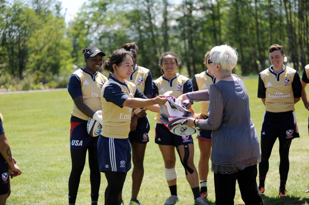 Kelly Griffin, captain of the USA Women&rsquo;s Rugby team, presents Barb Hanna — Communications and Marketing Director at City of Sequim — with a signed jersey and team rugby ball during a practice at the Albert Haller Playfields on May 25. Sequim Gazette photo by Michael Dashiell