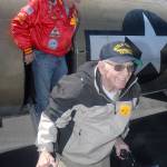 Veterans Don Alward, front, and Sid Gerling deboard a B-17 bomber after their flight with the Wings of Freedom Tour on June 21. Keith Thorpe/Peninsula Daily News