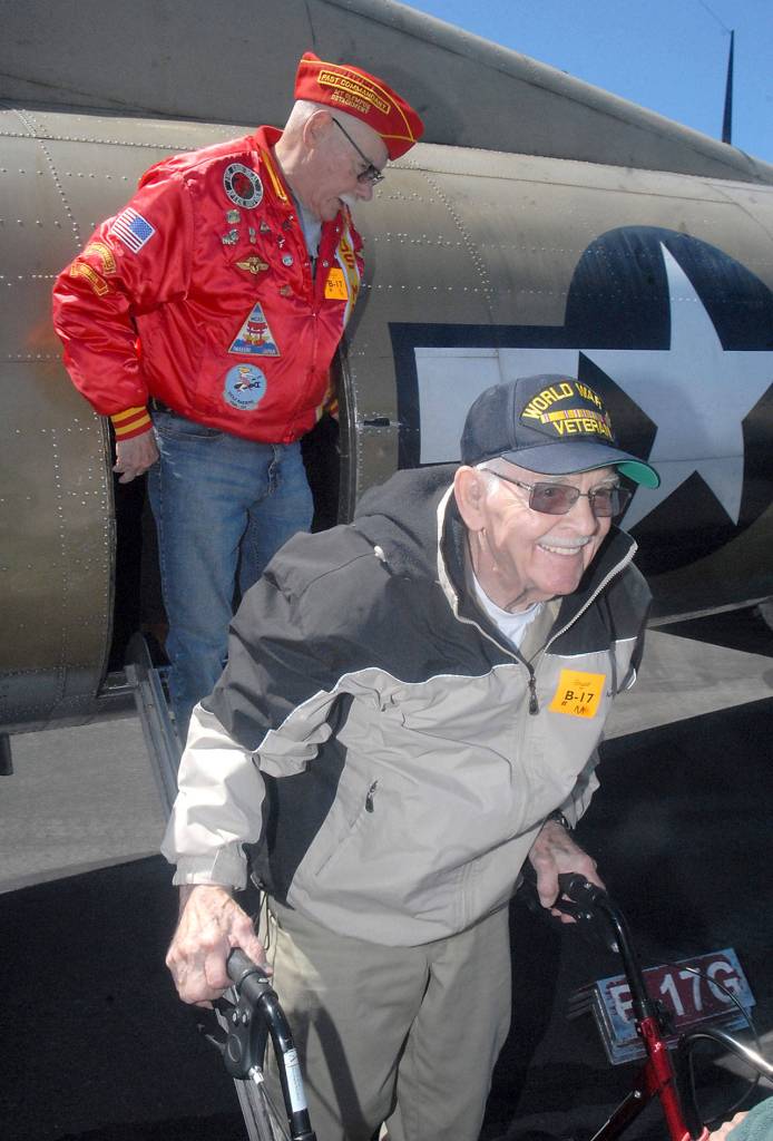 Veterans Don Alward, front, and Sid Gerling deboard a B-17 bomber after their flight with the Wings of Freedom Tour on June 21. Keith Thorpe/Peninsula Daily News