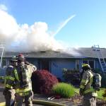 A fire spreads through the attic of a home on the 200 block of Griffith Farm Road on Sunday, June 4. Clallam County Fire District 3 with support from Clallam County Fire District 2 extinguished the fire in about two hours but the damage has displaced the homeowners. Sequim Gazette photos by Matthew Nash