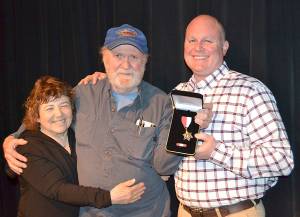 Deputy Don Kitchen, right, received the Clallam County Sheriff&rsquo;s Office Lifesaving Award on April 22 for administering CPR to Larry Buzzell, center, with assistance from the latter&rsquo;s wife Sue Chasen. Submitted photo
