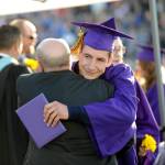 Issaiah Madison gets a hug from Sequim High administrator Randy Hill after receiving his diploma Friday night. Madison was bestowed the school&rsquo;s staff-selected &ldquo;U-Turn&rdquo; award for overcoming obstacles on his way to graduation. Sequim Gazette photos by Michael Dashiell