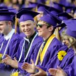 Shawn Jones, left, and fellow Sequim High School graduates give a hand to Grant Pierson, center, who gave two speeches at the SHS commencement ceremony Friday night: one as the faculty-selected speaker and a second as one of four Sequim High co-valedictorians. Sequim Gazette photo by Michael Dashiell