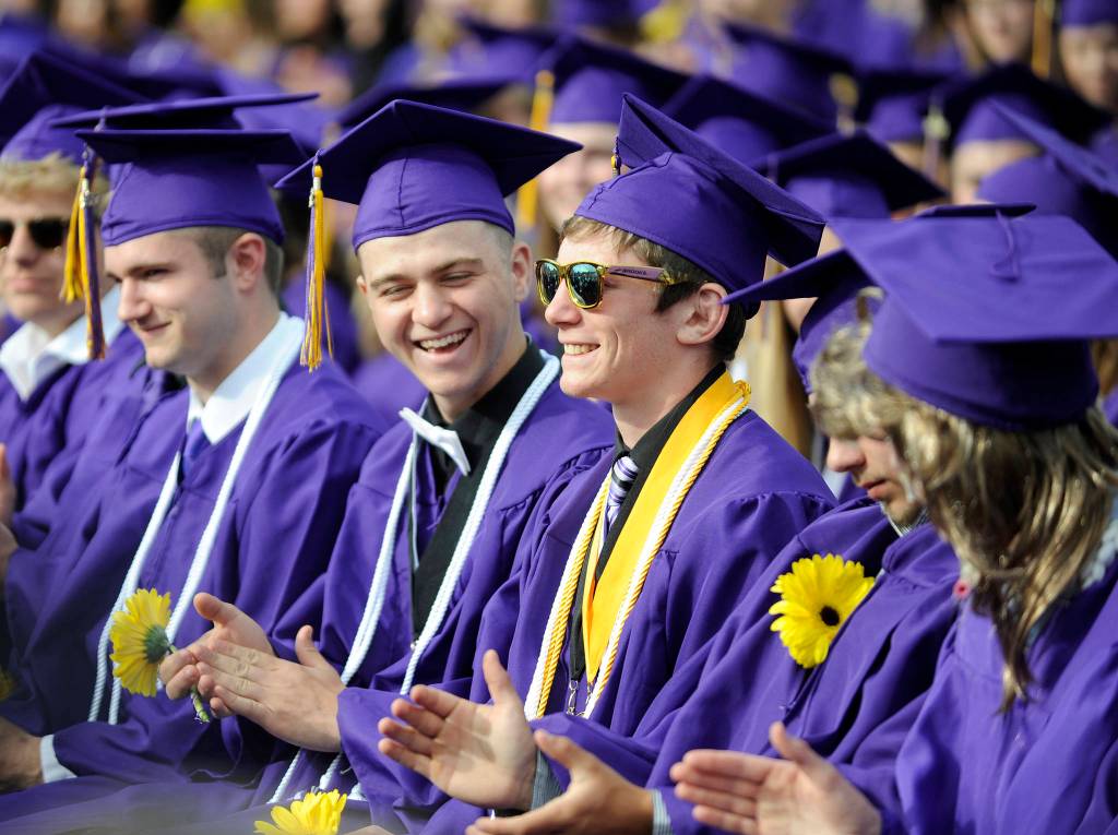 Shawn Jones, left, and fellow Sequim High School graduates give a hand to Grant Pierson, center, who gave two speeches at the SHS commencement ceremony Friday night: one as the faculty-selected speaker and a second as one of four Sequim High co-valedictorians. Sequim Gazette photo by Michael Dashiell