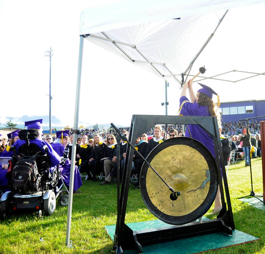 SHS senior Danica Miller prepares to strike a gong as she and fellow graduates receive their diplomas Friday night.