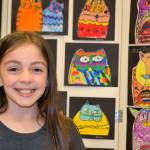 Madysyn Salazar, 9, of Rachel Oden&rsquo;s art class, likes her Laurel Burch piece best at the Helen Haller Adventures in Art Show. &ldquo;I love the way the colors are so bright,&rdquo; she said.