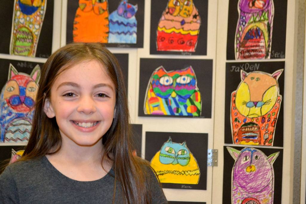 Madysyn Salazar, 9, of Rachel Oden&rsquo;s art class, likes her Laurel Burch piece best at the Helen Haller Adventures in Art Show. &ldquo;I love the way the colors are so bright,&rdquo; she said.