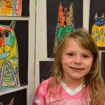 Bailey Fatherson, 6, a kindergartener in Stephanie Grotzke-Nash&rsquo;s class, stands with her art following Laurel Burch. It&rsquo;s her favorite piece, she said, &ldquo;because I like kitties.&rdquo; Sequim Gazette photo by Matthew Nash