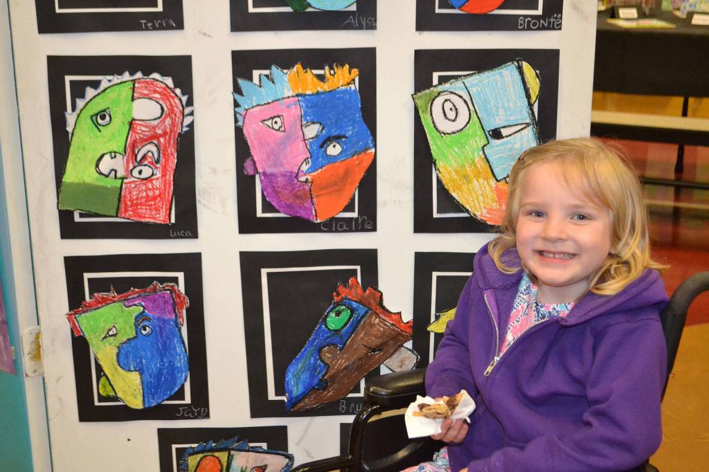 Claire Hardy, kindergartener in Stephanie Grotzke-Nash&rsquo;s class, poses with her piece of art following Pablo Picasso&rsquo;s style. Sequim Gazette photo by Matthew Nash