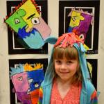 Alyssa L&rsquo;Ami, kindergartener in Stephanie Grotzke-Nash&rsquo;s class, poses with her piece of art following Pablo Picasso&rsquo;s style.