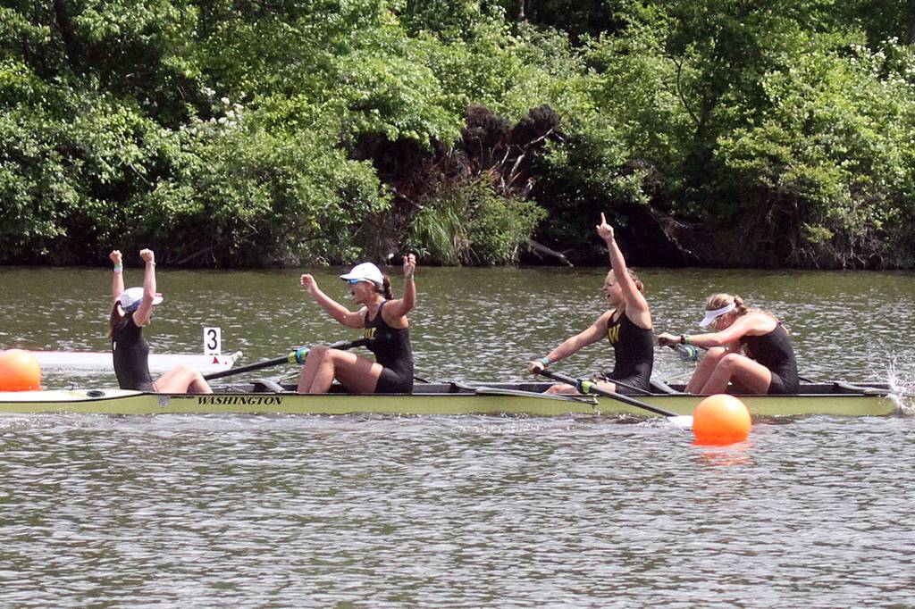 Varsity eight teammates for the University of Washington, including Elise Beuke, third from left, celebrate after crossing the finish line to earn a first-place finish on May 28. Photo courtesy of University of Washington.