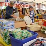 Terry and Sam Marsh, members of Sequim Worship Center, help set up the Royal Rangers fireworks booth on June 27 near Sequim JCPenney. It is one of four booths in Sequim city limits selling fireworks from June 28-July 5. Next year, the City of Sequim&rsquo;s ban on discharing consumer fireworks is implemented but booth sales will continue. Sequim Gazette photo by Matthew Nash