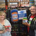 Andra Smith, executive director of the Sequim Food Bank, and Stephen Rosales, board president for the food bank, stand with more than 3,000 jars of peanut butter in the Sequim Food Bank. The peanut butter was donated during the Price Ford Peanut Butter Drive last weekend at local grocery stores. With cash donations, they estimate they&rsquo;ll bring in just over 4,000 jars to help local youth. Sequim Gazette photo by Matthew Nash