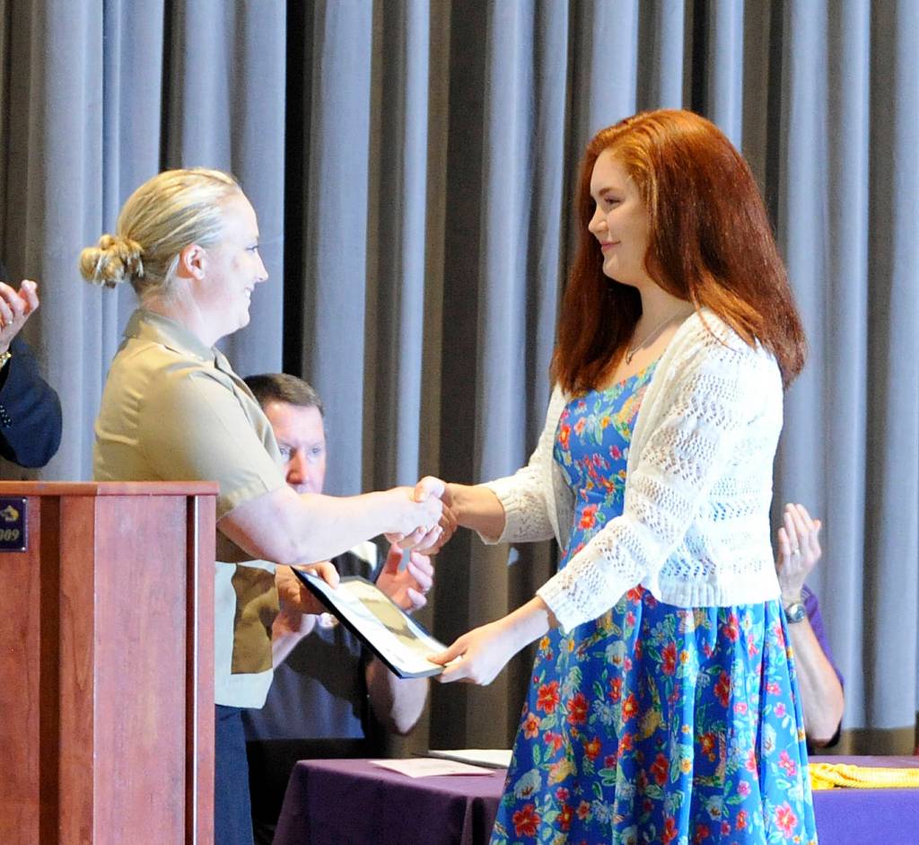 Sequim High School senior Stephanie Grow, right, accepts her U.S. Navy Post 911 Educational Benefit scholarship (worth $110,000) from Petty Officer Wendy Schwandt. Sequim Gazette photo by Michael Dashiell
