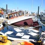 Personnel from Global Diving and Salvage work to secure leaking fuel from the Seattle-based Lady Mick, which began sinking July 18 at John Wayne Marina. Sequim Gazette photo by Michael Dashiell