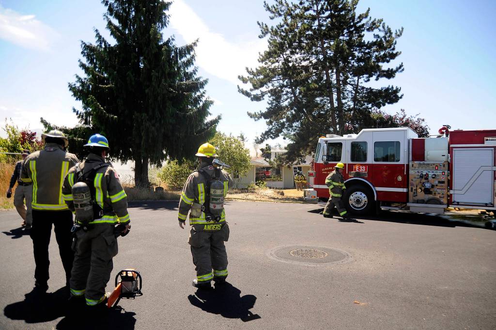 Firefighters from Clallam County District 3 respond to an attic fire in Carlsborg on July 18. No injuries were reported in the incident. Sequim Gazette photo by Michael Dashiell