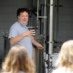 Paul Schiefen of Jardin du Soleil Lavender explains the lavender distilling process to curious onlookers at the Sequim farm on July 21. Sequim Gazette photo by Michael Dashiell