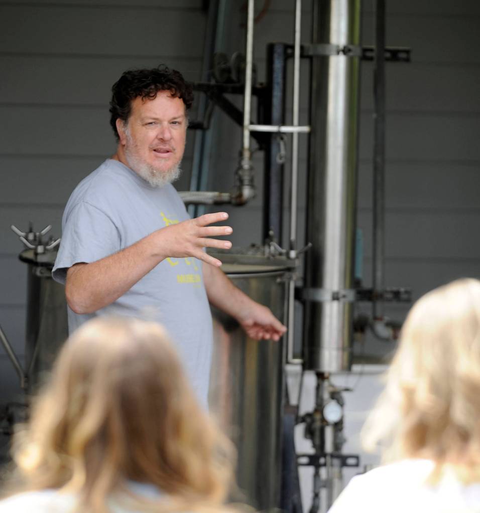 Paul Schiefen of Jardin du Soleil Lavender explains the lavender distilling process to curious onlookers at the Sequim farm on July 21. Sequim Gazette photo by Michael Dashiell
