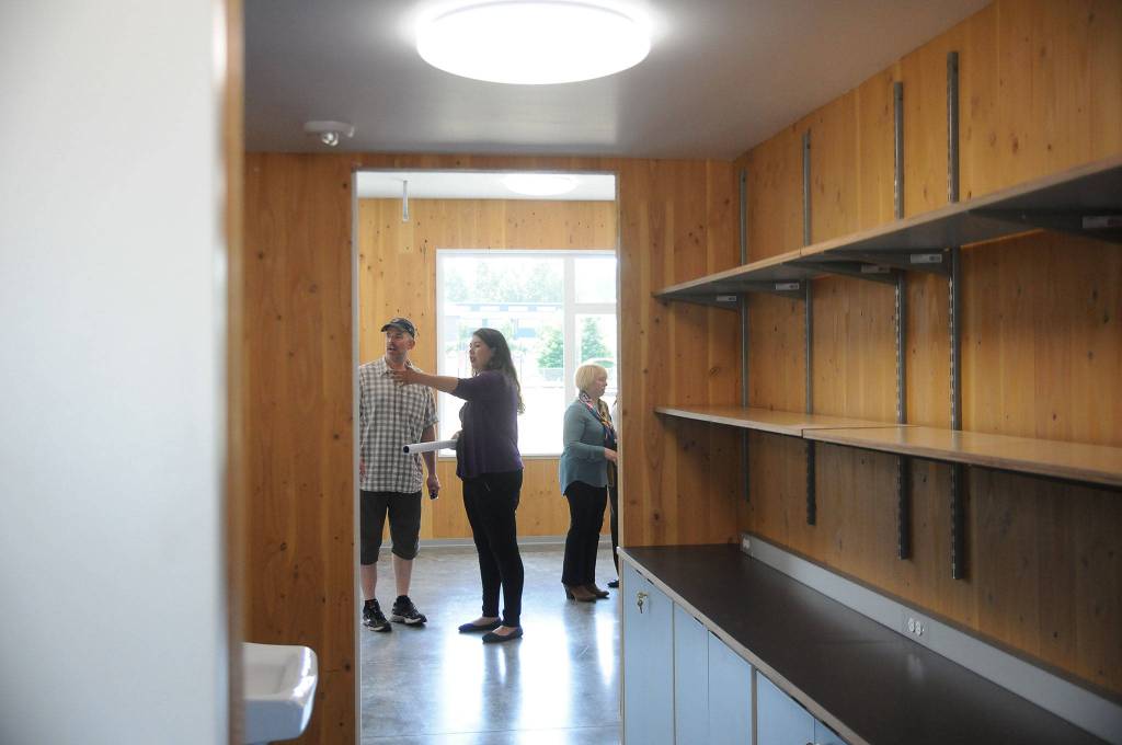 Sequim teacher Eric Danielson and Jodi Minker, administrative assistant with the Sequim-Dungeness Valley Chamber of Commerce, get a glimpse of the new classroom building at Greywolf Elementary School. Sequim Gazette photo by Michael Dashiell