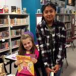 Greywolf Elementary School kindergartener Emma Simpson, left, and fifth-grader Hailey Onofre find a great way to start each day is to find a quiet place and read, by themselves or with a family member. Some students come to the Early Bird Reader program in the school library only occasionally while others like Onofre and Simpson come almost every day. Over the course of the school year, more than 120 different students participated in the Early Bird Reader program. Photo by Katie Salmon-Newton