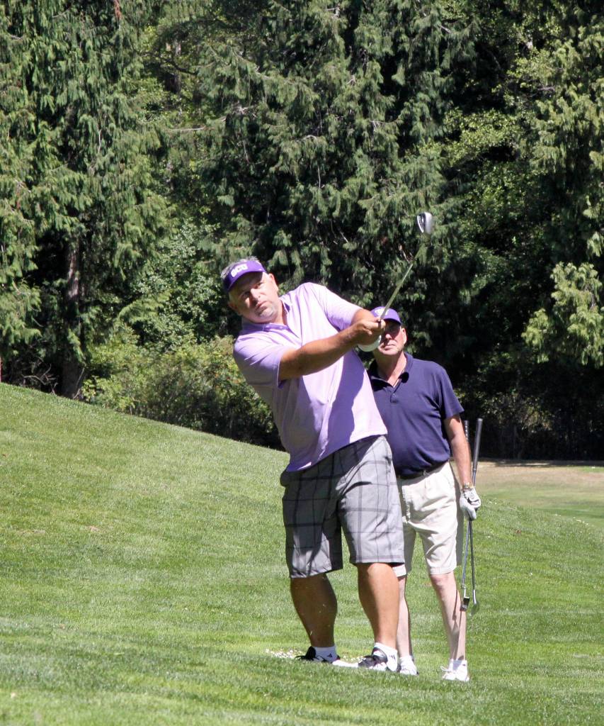 Sequim High grad Derrin Doty makes an approach to the green at the Sonny Sixkiller golf tournament at The Cedars at Dungeness on July 28. Doty played baseball at the University of Washington and was drafted by the California Angels in 1993. Photo by Dave Logan