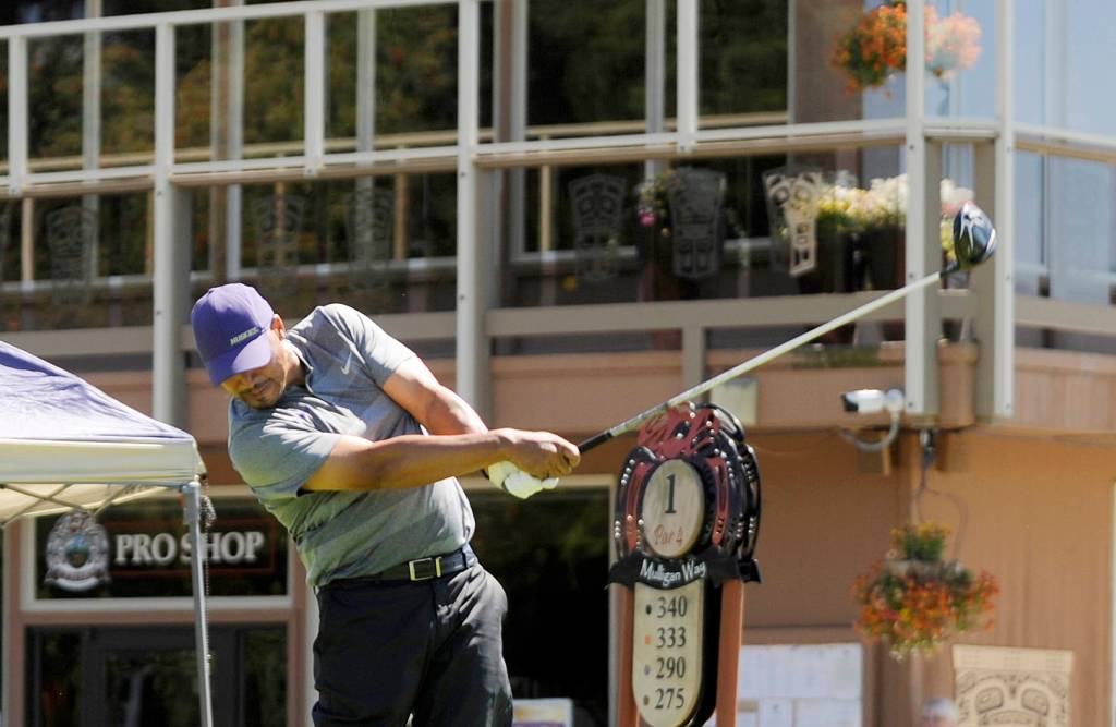 Jason Hamilton, former UW basketball star and current radio broadcaster for the Dawgs, tees off at the first hole at The Cedars at Dungeness on July 28, playing in the annual Sonny Sixkiller Husky Golf Classic. Sequim Gazette photo by Michael Dashiell