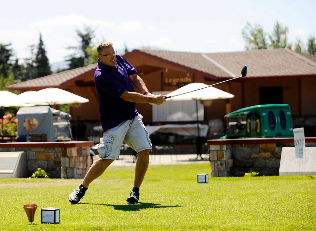 Tom Baermann tees off on the first hole at The Cedars at Dungeness on July 28, playing in the annual Sonny Sixkiller Husky Golf Classic . Sequim Gazette photo by Michael Dashiell