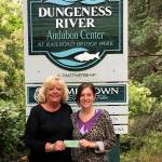 The Newcomers&rsquo; Club recently donated $200 to the Dungeness River Audubon Center in appreciation of its commitment to provide educational and environmental programs for adults and children. Jenna Ziogas, right, education and volunteer coordinator of the center, accepts the donation from Cathy Schau, Newcomers&rsquo; Club president. Submitted photo