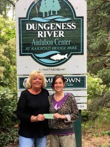 The Newcomers&rsquo; Club recently donated $200 to the Dungeness River Audubon Center in appreciation of its commitment to provide educational and environmental programs for adults and children. Jenna Ziogas, right, education and volunteer coordinator of the center, accepts the donation from Cathy Schau, Newcomers&rsquo; Club president. Submitted photo