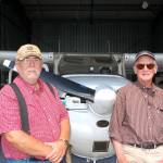 Sequim residents and airplane owners Dan Ramberg, left, and John Meyers stand in Ramberg&rsquo;s airplane hangar at the Sequim Valley Airport. Ramberg and Meyers are both participating pilots for the Young Eagles Rally on Saturday, Aug. 12, giving free airplane rides to youth ages 8-17. Sequim Gazette photo by Erin Hawkins