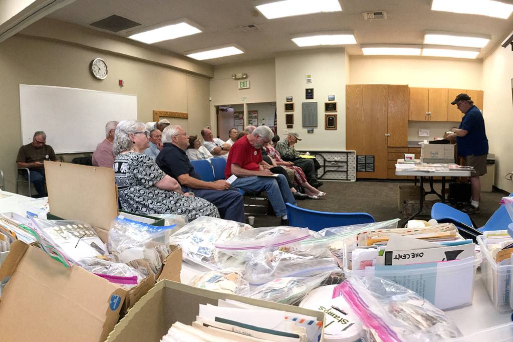 Strait Stamp Society members gather on Aug. 2 in the Sequim Library for their monthly meeting. There they discussed logistics for their 24th annual show on Aug. 12 and some of their recent discoveries while collecting. Sequim Gazette photo by Matthew Nash